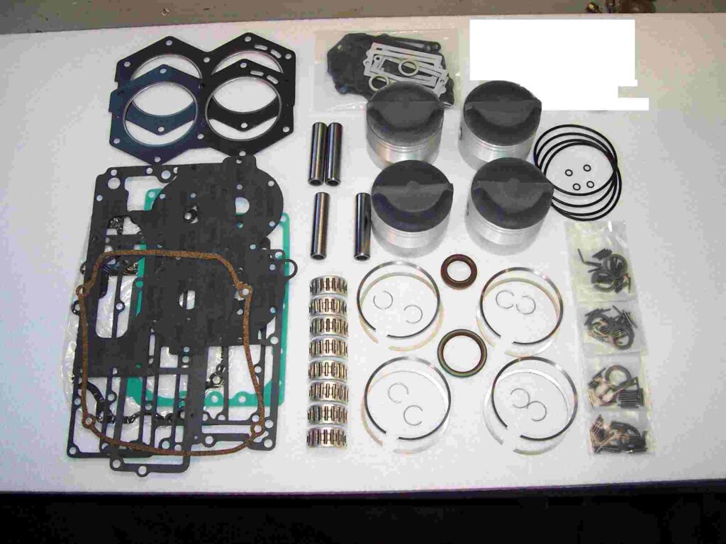 A table with many different parts of a engine.