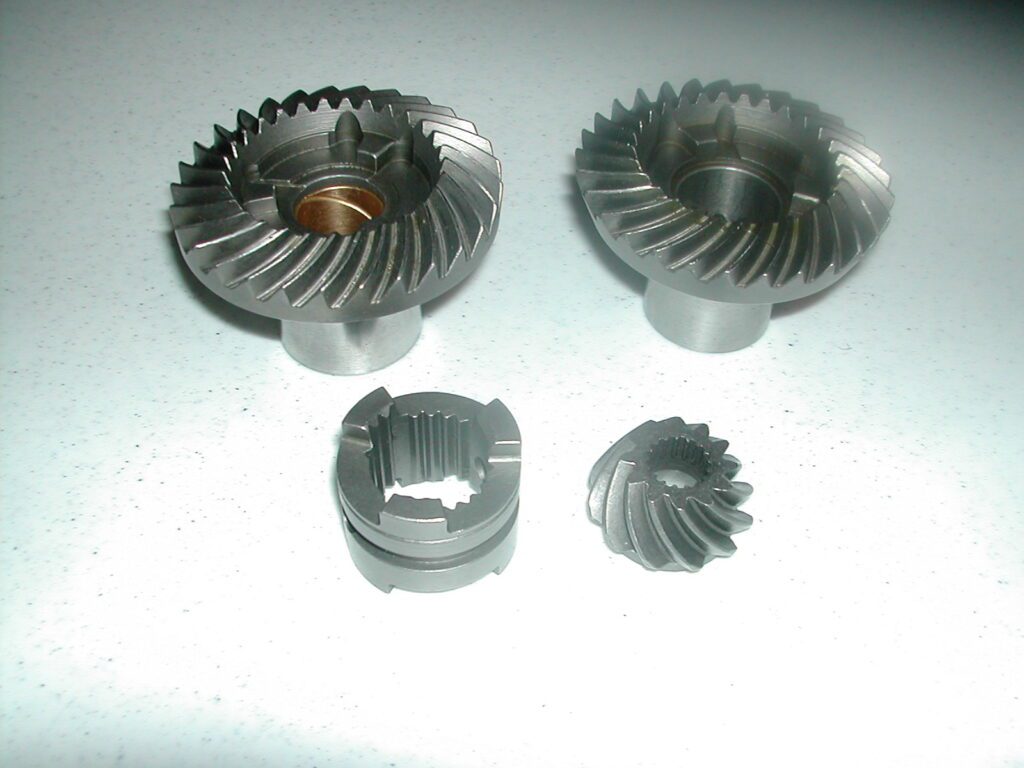 A set of four metal gears sitting on top of a table.