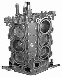 A large engine block with four valves and two different sizes.